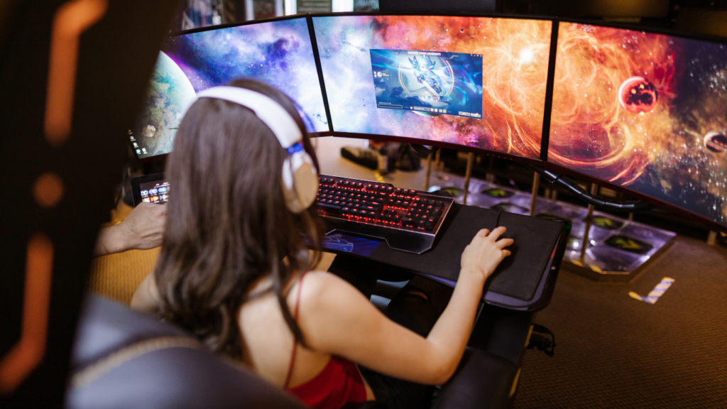 A person is sitting in front of a computer with headphones on