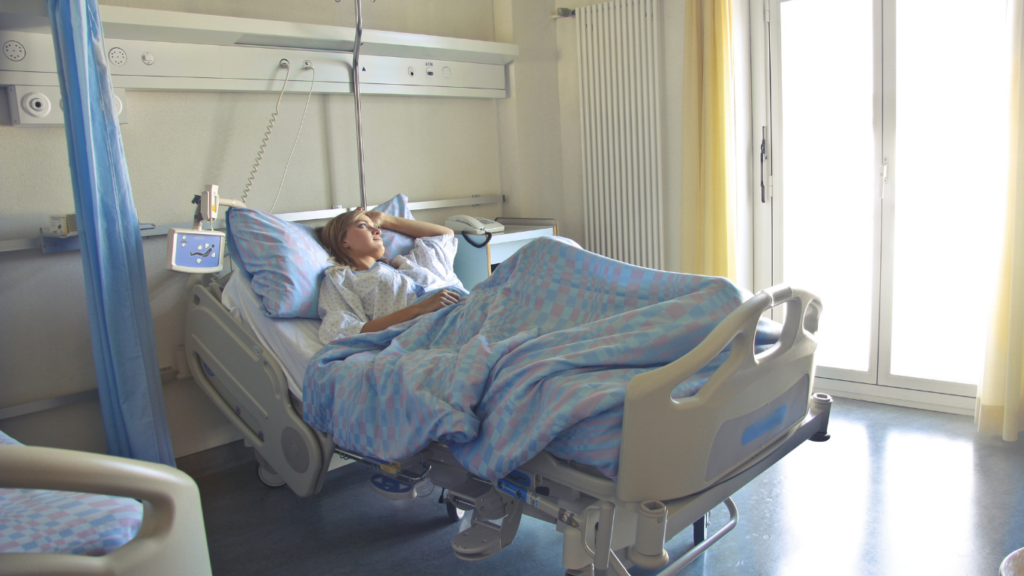 A person lying in a hospital bed