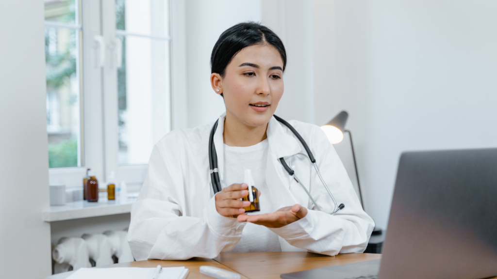 A doctor is sitting in front of a laptop