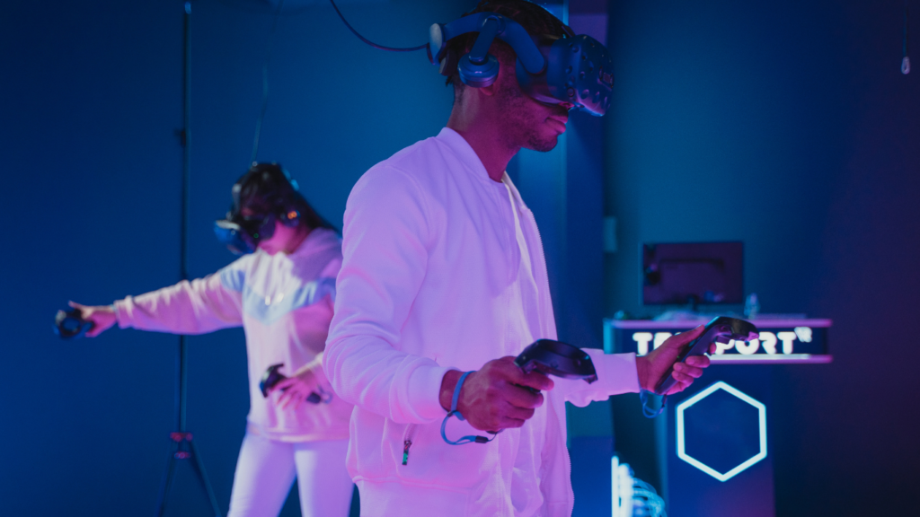 a person wearing a virtual reality headset and another person standing next to them