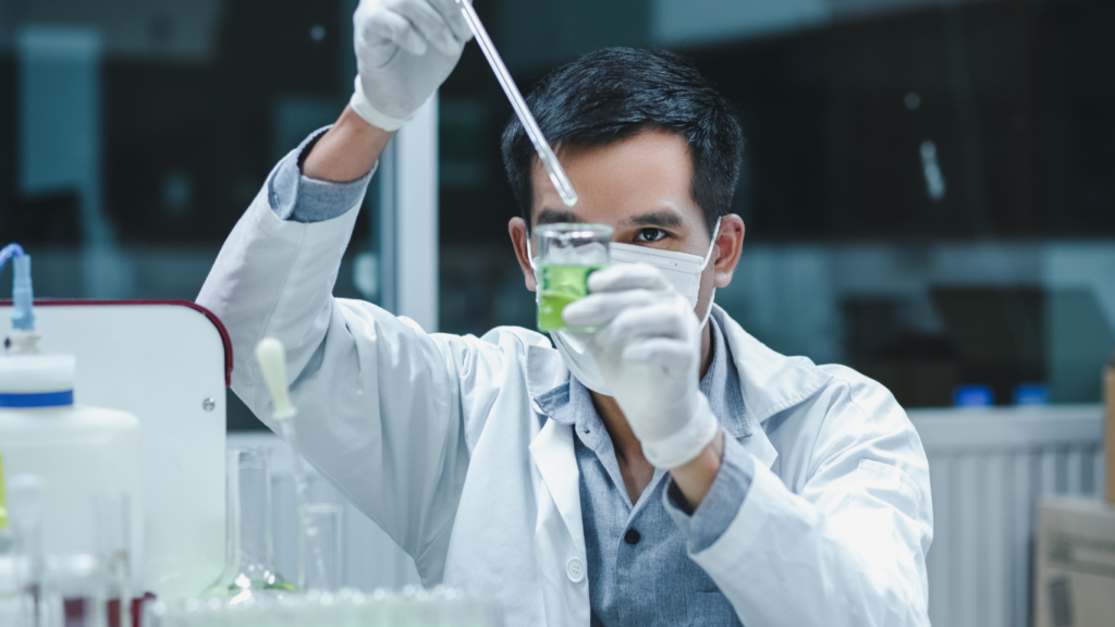 a person in a lab coat is holding a test tube