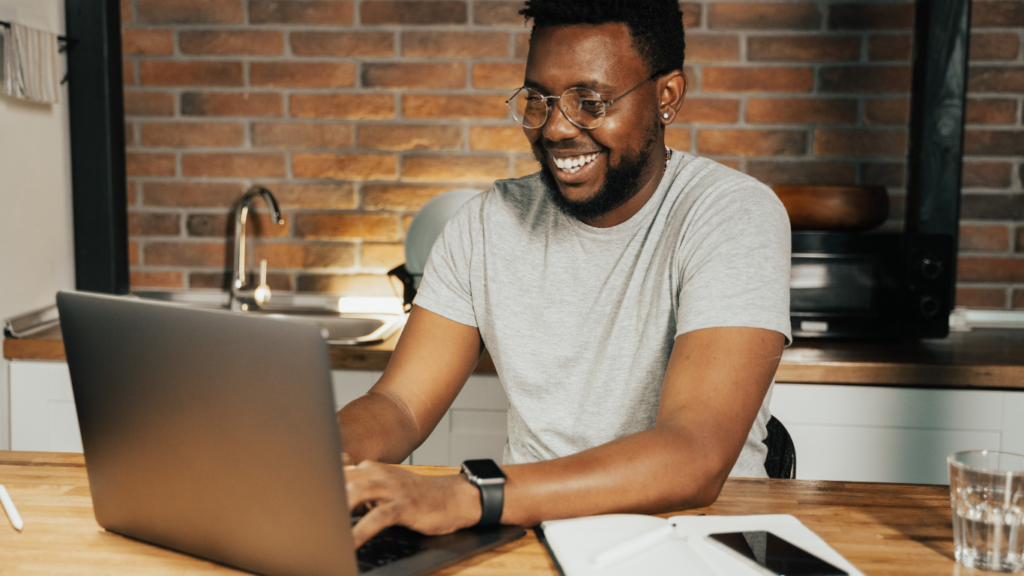 A person sitting at a table with a laptop