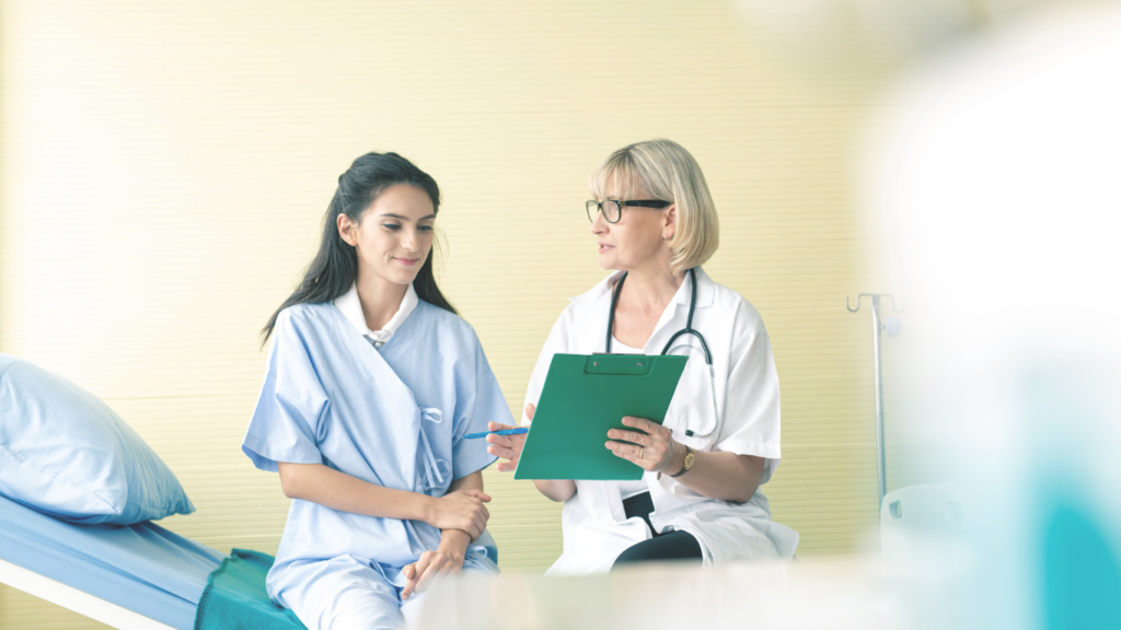 a doctor talking to a patient in a hospital bed