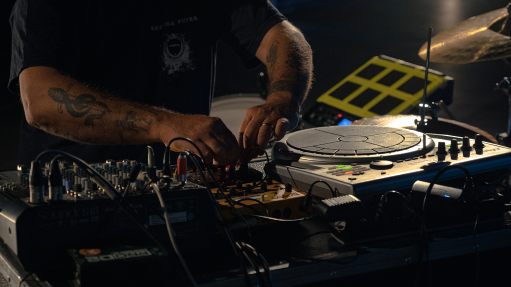 a person in a black shirt is working on a mixing board