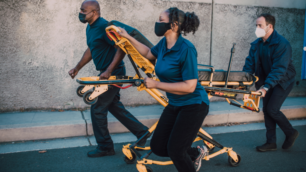 a person is being carried on a stretcher by an emergency worker