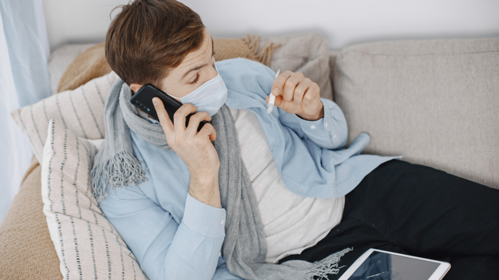 a person wearing a face mask is sitting on a couch