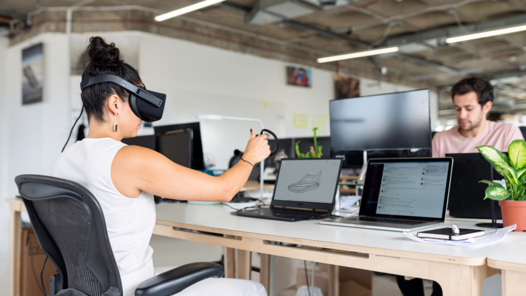 a person wearing a virtual reality headset and another person standing next to them