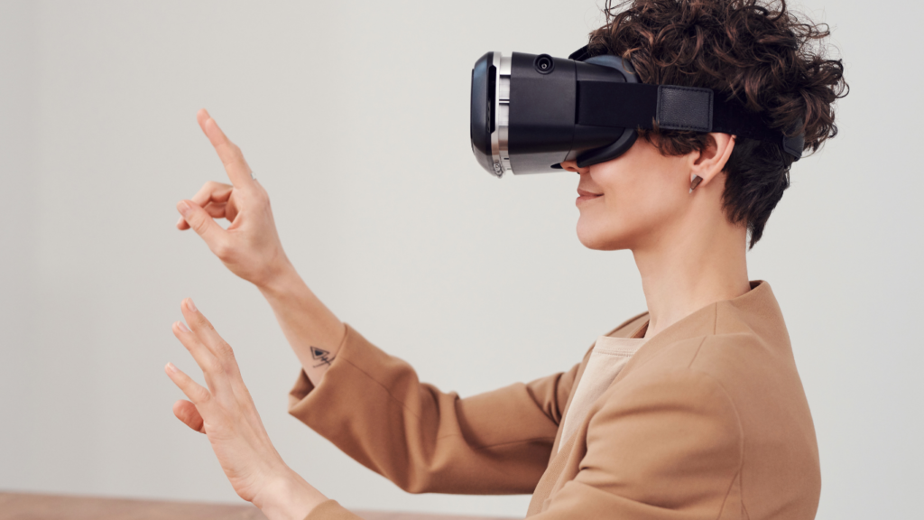 a person wearing virtual reality glasses at a desk