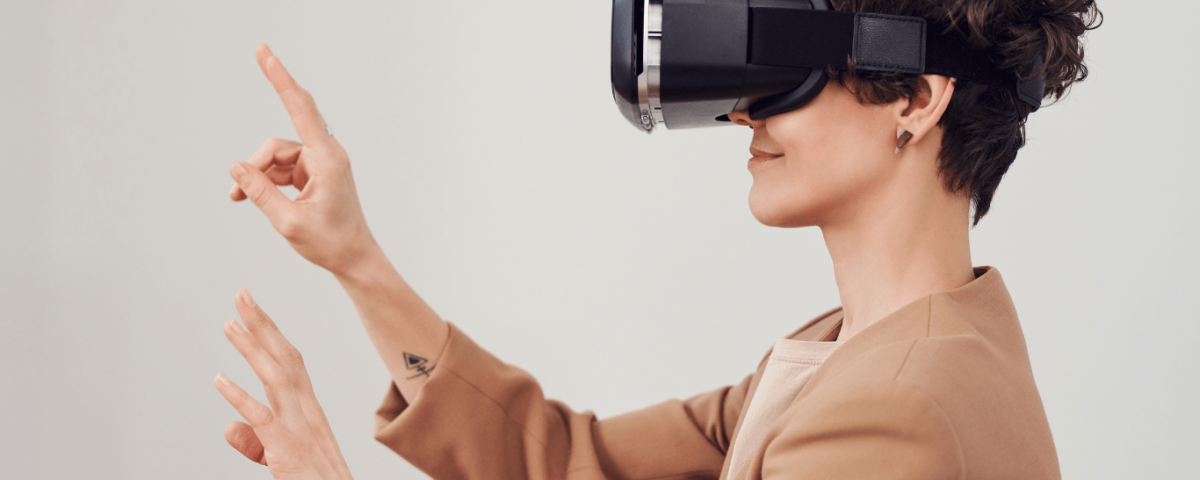 a person wearing virtual reality glasses at a desk